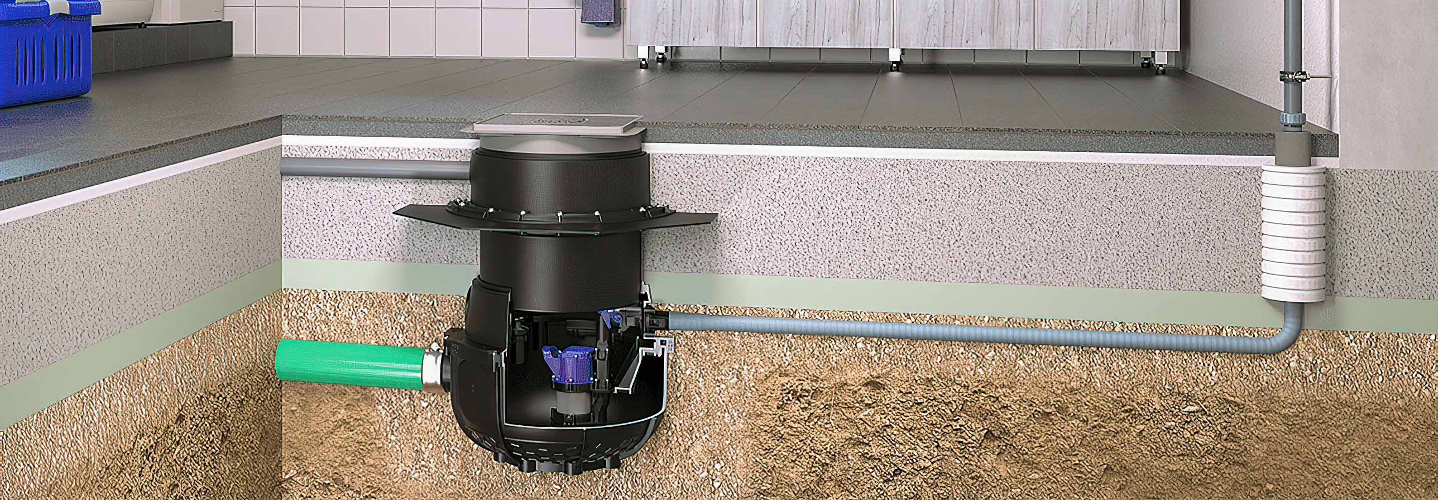 Die Abbildung zeigt einen Waschraum, in dessen Fußboden eine Hebeanlage Aqualift in einem befliesbaren Schachtmodul eingebaut ist